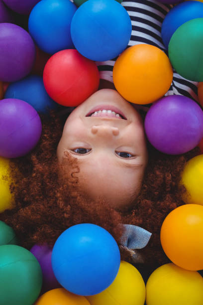 istock Cute smiling girl in sponge ball pool 666529592