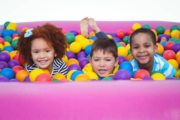 Cute smiling kids in sponge ball pool looking at camera