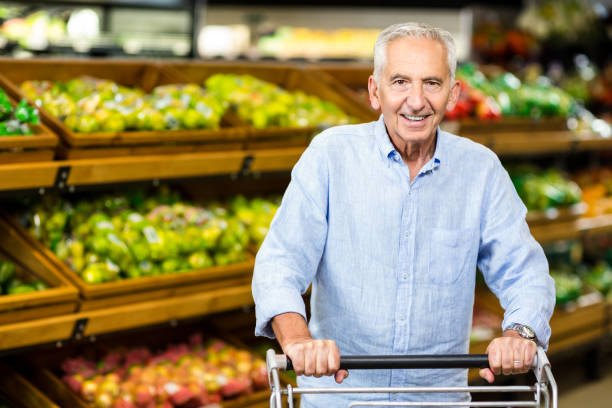 istock Smiling senior man holding trolley 666530128