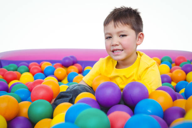 istock Cute smiling boy in sponge ball pool 666530144