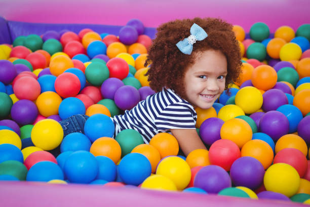 istock Cute smiling girl in sponge ball pool 666530266
