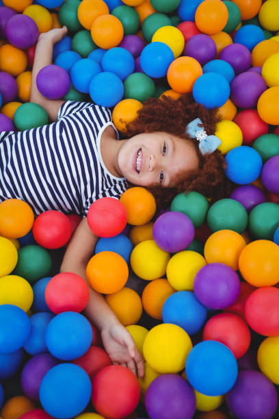 istock Cute smiling girl in sponge ball pool 666530310