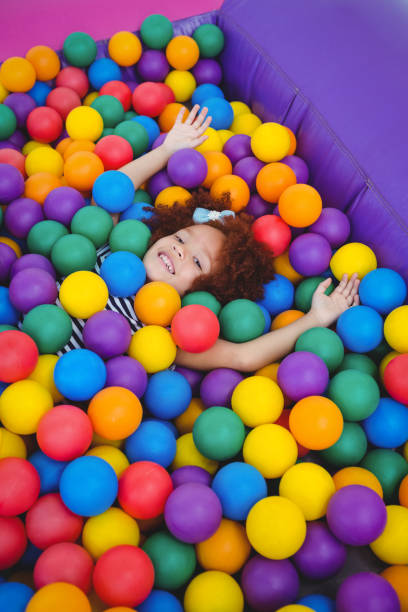 istock Cute smiling girl in sponge ball pool 666530418