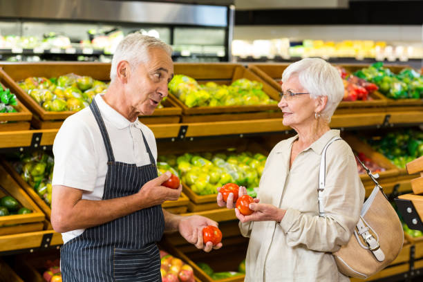 istock Senior customer and worker discussing vegetables 666530474
