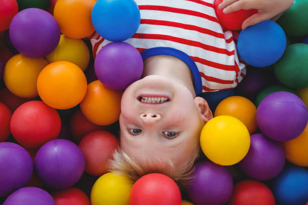istock Cute smiling boy in sponge ball pool 666530618