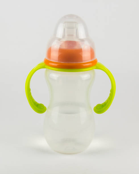 istock Baby bottle with water on a white background 666539410