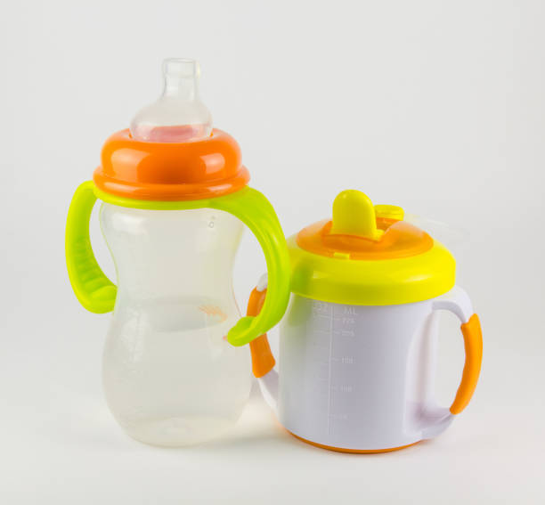 istock Baby bottles with water on white background 666539414