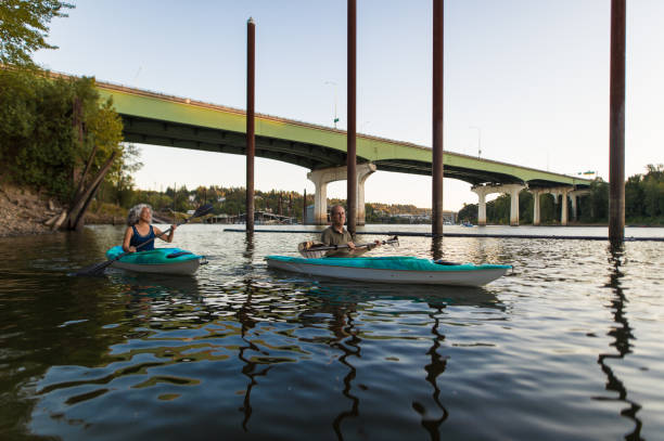 istock Older mature couple kayaking together during summer 666540184