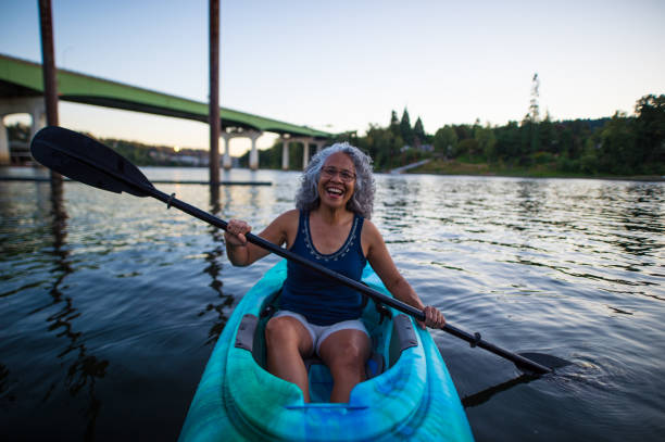 istock Ethnic female senior citizen kayaks in river 666540192