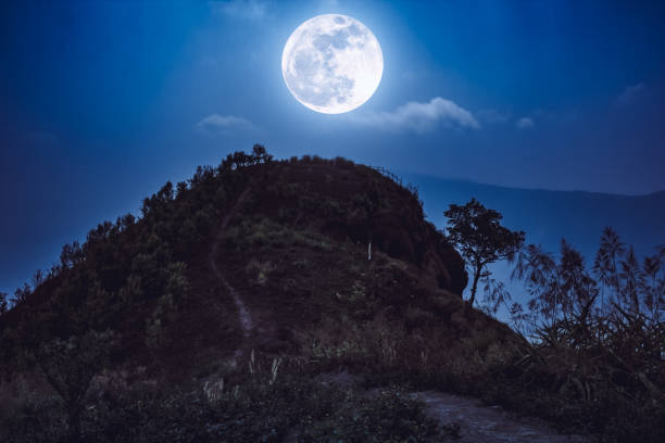 istock Mountain peaks with sky and beautiful full moon. 666540386