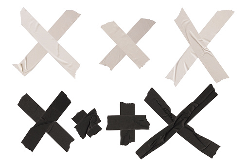 Many torn cross black and white adhesive tape isolated on white.