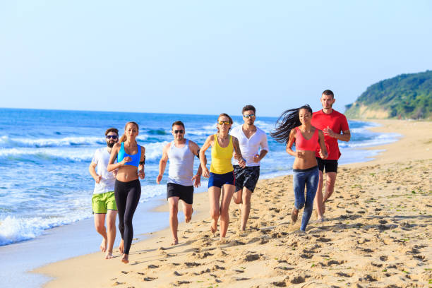 istock Group of sportmen jogging on beach 666545348