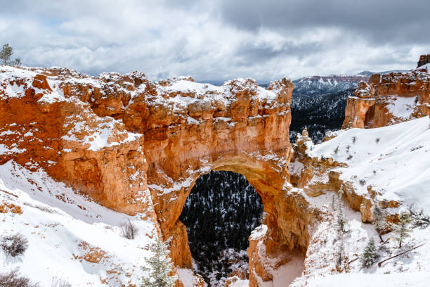 istock Natural Arch formation with snow in Bryce Canyon, Utah. 666545526
