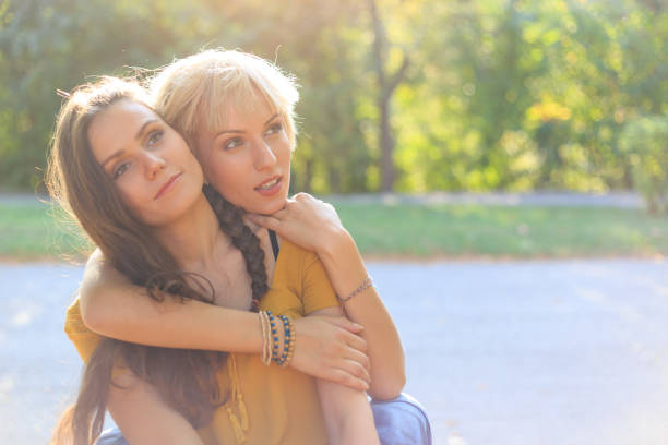 istock Young women relaxing and embracing 666545542