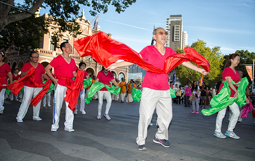 Asian dancers rehearse for the opening parade for Parramasala - a major festival celebrating multiculturalism in Sydney, Australia. There is some motion blur.