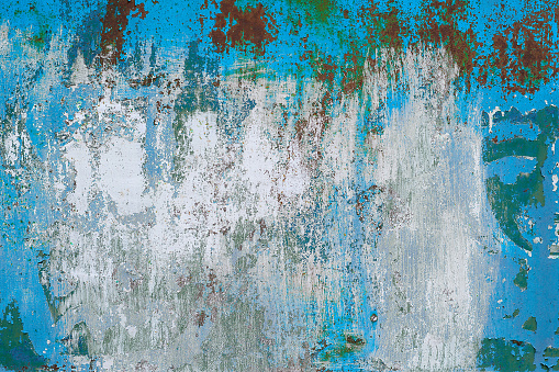 Texture of vintage painted iron wall background with many layers of paint