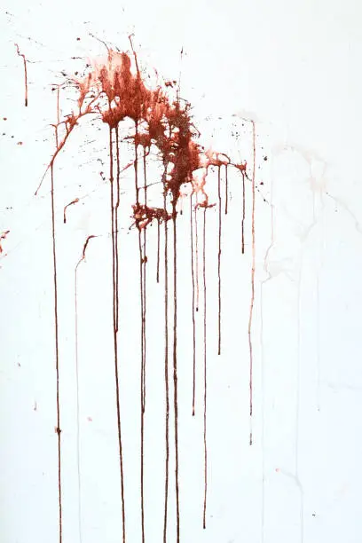 Photo of Background texture cement white wall with red blood-like paint streaks