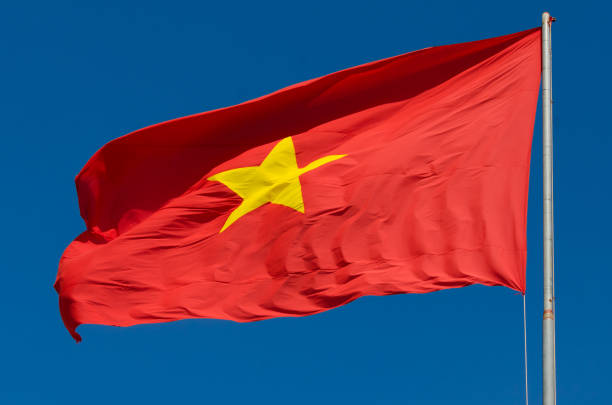 istock The flag of Vietnam (red flag with a gold star) fluttering on blue sky 666556876