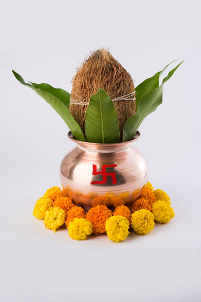 istock copper kalash with coconut and mango leaf with floral decoration. essential in hindu puja, selective focus, over plain background 666559426