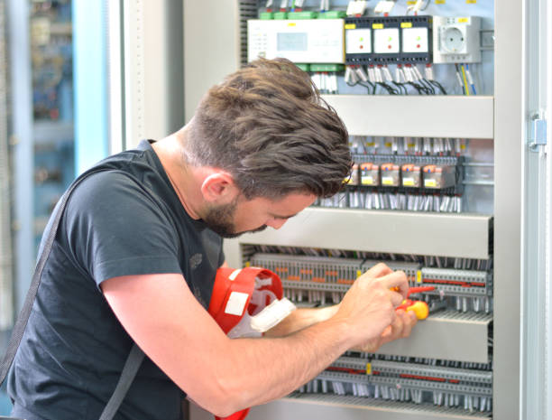 Handsome electrician working with work tool in electrical room Electrician is repairing electrical failure on the terminal blocks. electrical fuse stock pictures, royalty-free photos & images