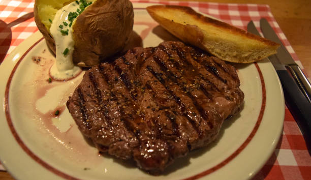 istock German steak. Medium rare roast beef with sauce and potato 666573366