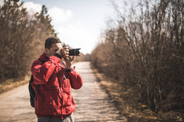 istock Photographer is making photos on the forest road 666573536