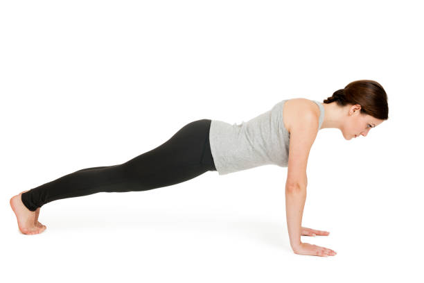 Yoga woman gray position_chaturanga stock photo