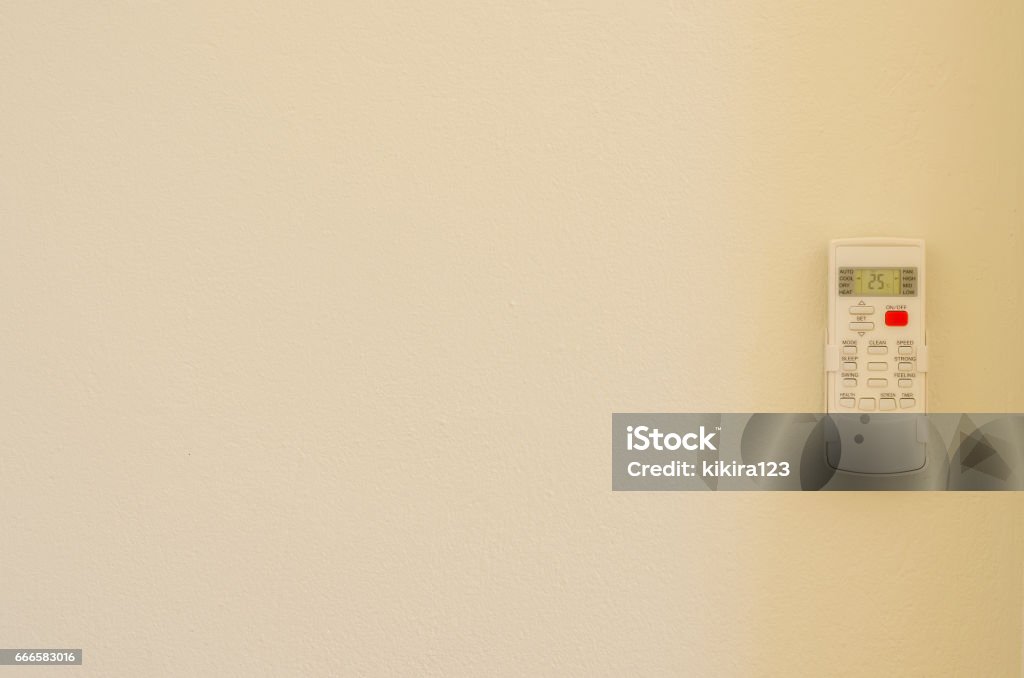 Air conditioner remote control on wall background Air Conditioner Stock Photo