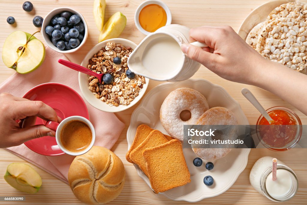 Rich breakfast table. Pouring milk and coffee. Top view Breakfast Stock Photo