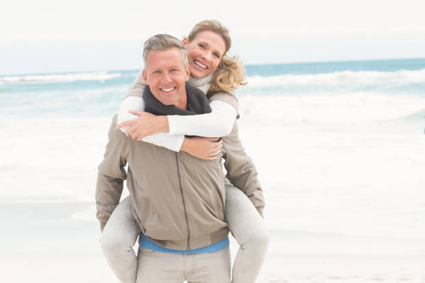 istock Smiling man giving woman a piggy back 666587390