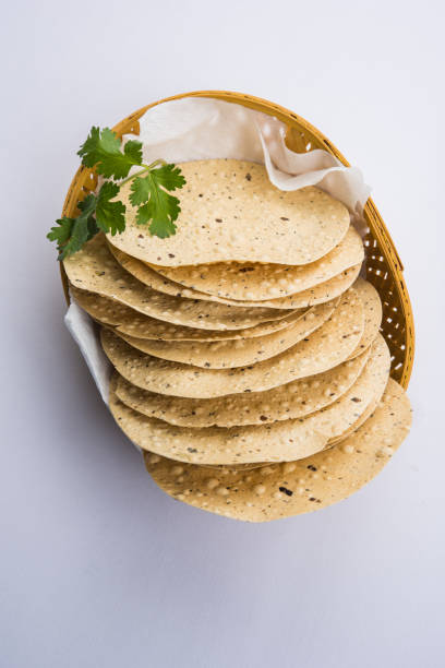 istock Indian snacks, deep fried crackers or papad. Mung dal and urad dal papad an Indian fried dish, which is an side dish for lunch and dinner 666589950