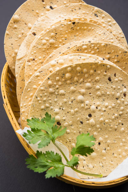 istock Indian snacks, deep fried crackers or papad. Mung dal and urad dal papad an Indian fried dish, which is an side dish for lunch and dinner 666593410