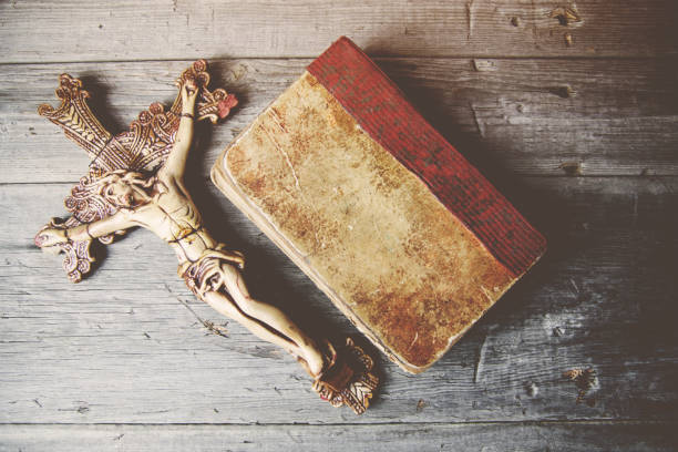 istock Crosses and book on a wooden table 666595826