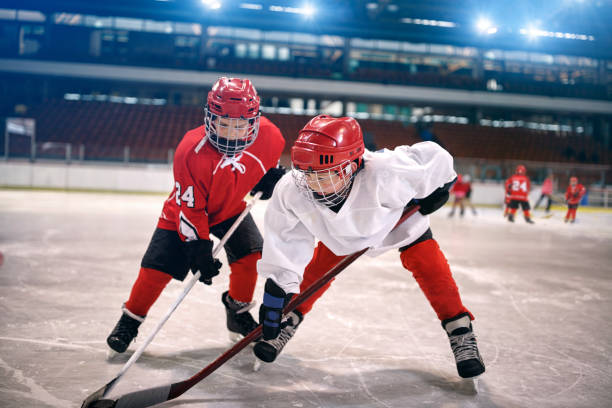 bambini giocano a hockey su ghiaccio - hockey su ghiaccio foto e immagini stock