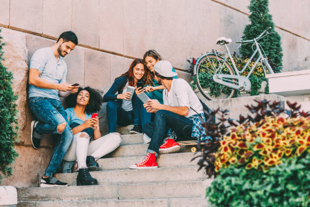 istock Friends browsing the net outdoors 666607640