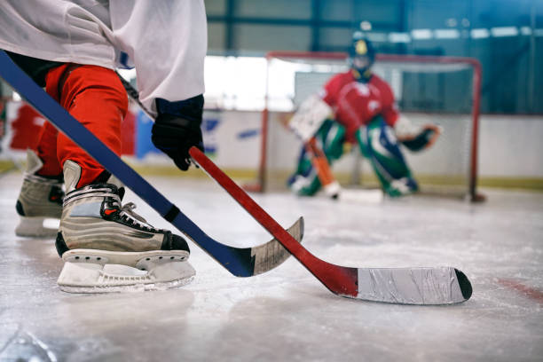 istock ice hockey player in action kicking with stick 666607928