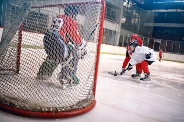 istock hockey goals, shoots the puck and attacks goalkeeper 666608120