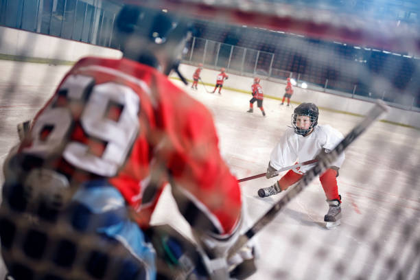istock Hockey match at rink player attacks goalkeeper 666610436