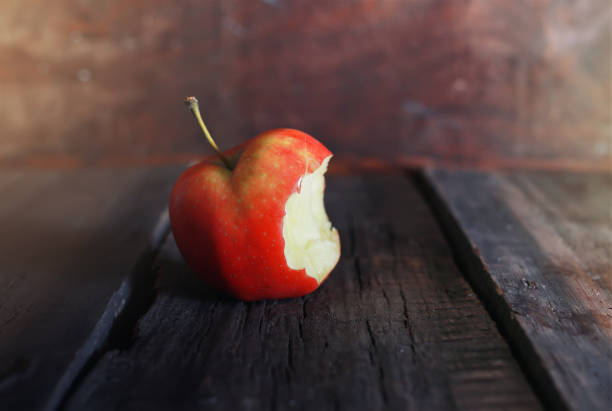 red bitten apple Fresh fragrant and juicy fruits on the wooden background image of a healthy diet apple with bite out stock pictures, royalty-free photos & images