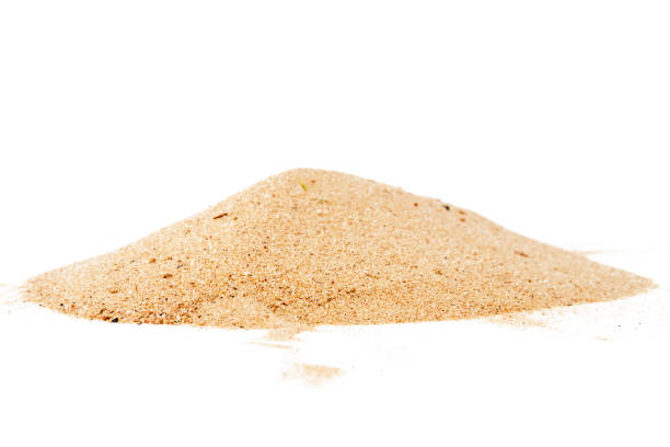 Pile of yellow sand isolated on white background, selective focus at front