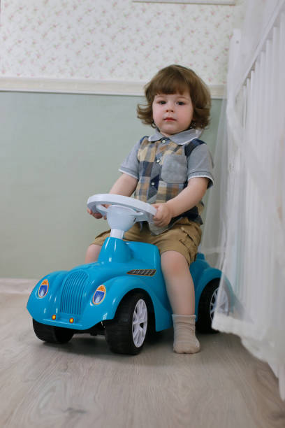 istock litle boy sit on a toy car 666620078