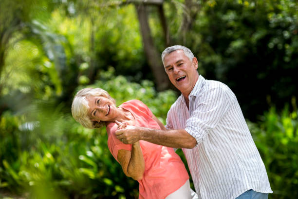 istock Senior couple enjoying while dancing in yard 666621052