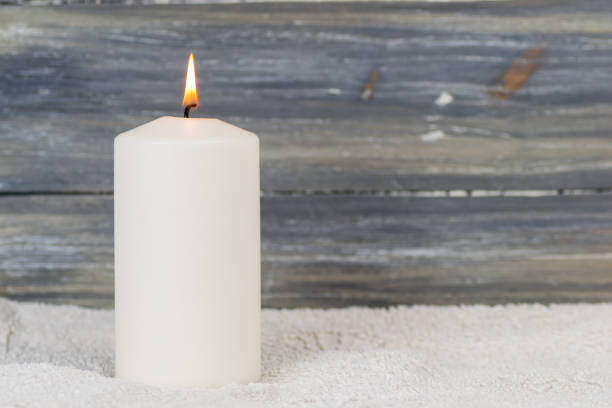 a candle is lit in the darkness and gives spiritual warmth