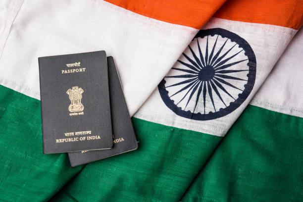 indian passport and authentic indian tricolour flag made up of khadi or pure cotton material stock photo