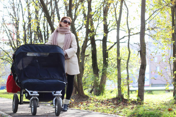 istock girl in the park with stroller 666631350
