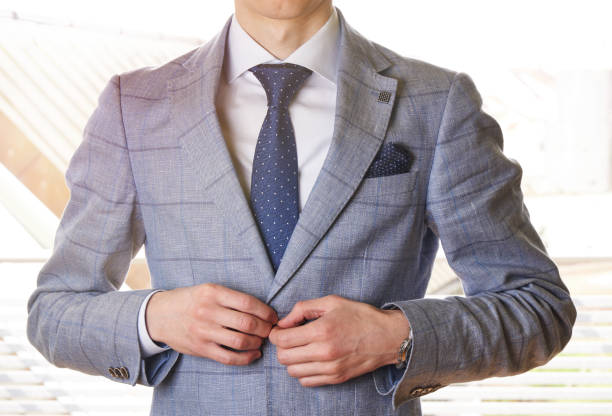 istock Unrecognizable businessman buttons his jacket up - in sunshine 666634282