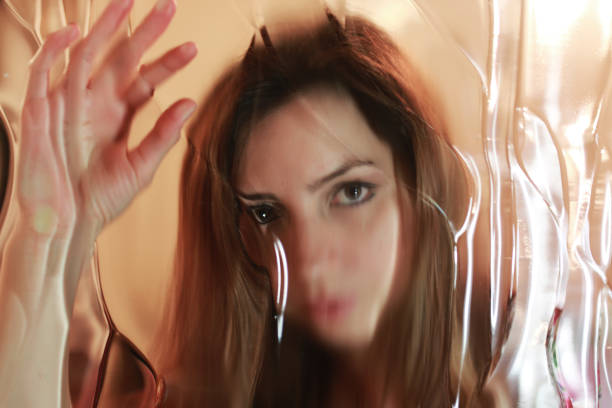 istock girl face behind glass 666637404