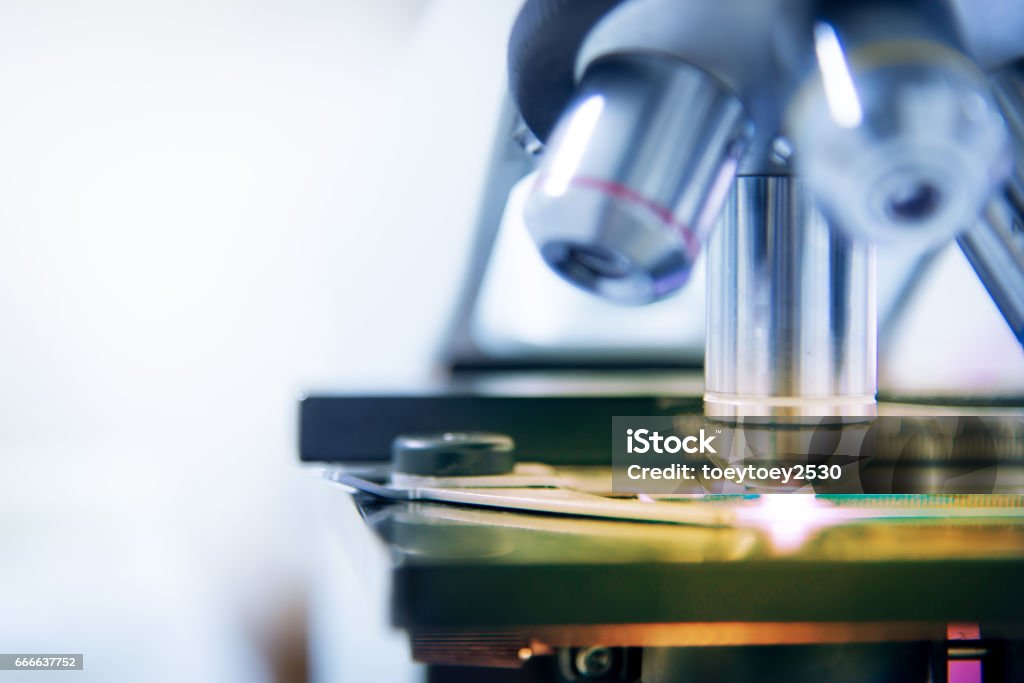 Microscpope laboratory equipment find test in white tone. Microscope Stock Photo