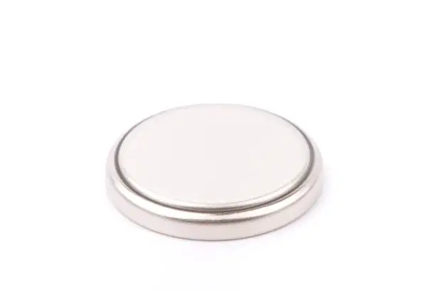 Photo of Small button battery isolated on white background.