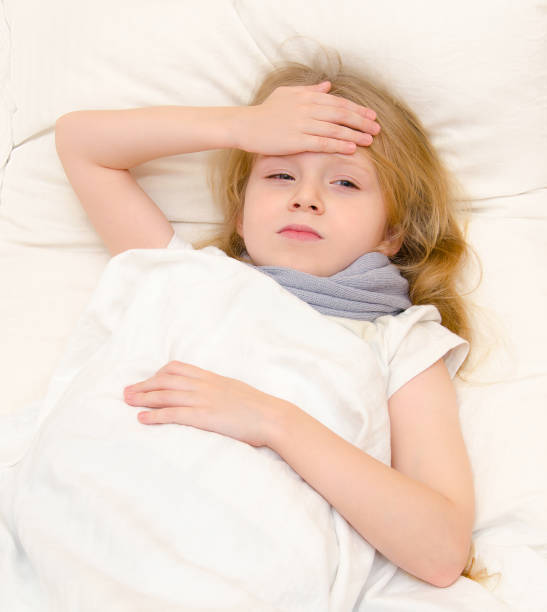 istock Sick little girl lying in the bed 666644832
